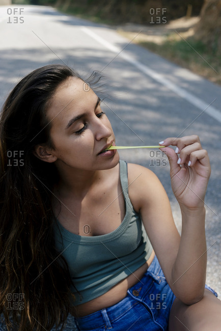 Young pretty girl chewing a gum outdoors