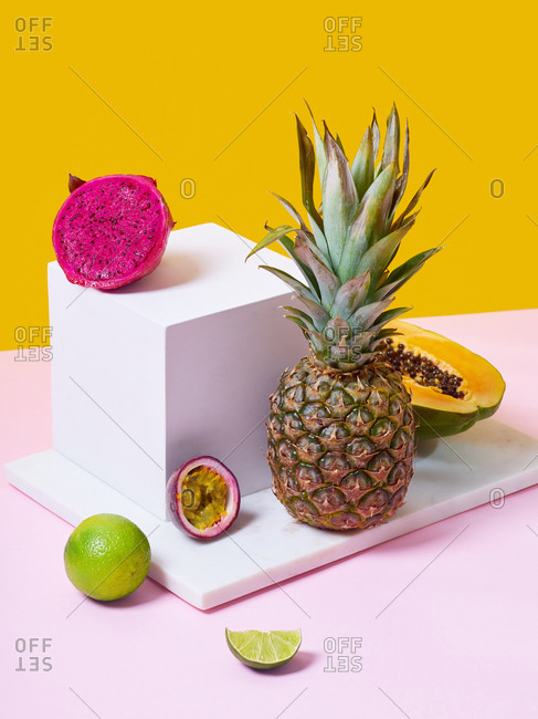 Still life with tropical fruits on colorful background