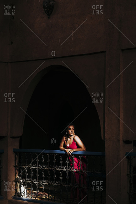 Portrait of young woman leaning on railing looking at distance Morocco