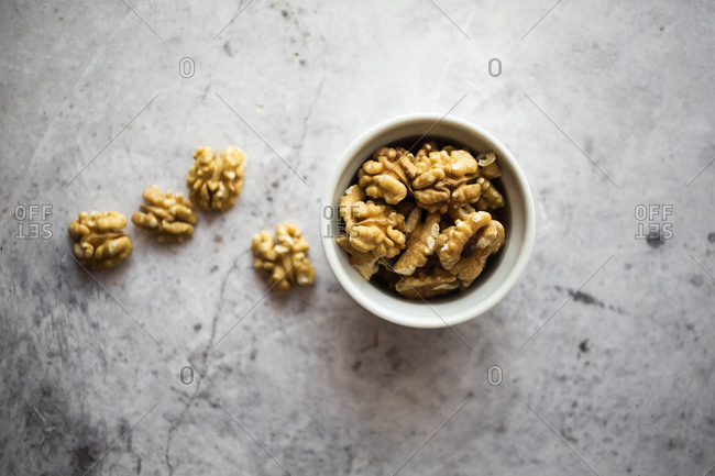 Bowl of peeled walnuts on a table