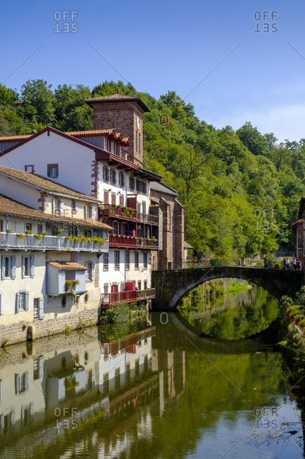 September 13, 2019: France- Pyrenees-Atlantiques- Saint-Jean-Pied-de-Port- Old town houses and Pont Saint Jean reflecting in Nive canal