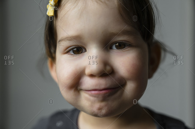 Portrait of smiling little girl with brown eyes