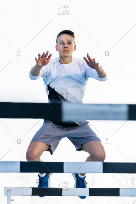 Athlete crossing a hurdle outside
