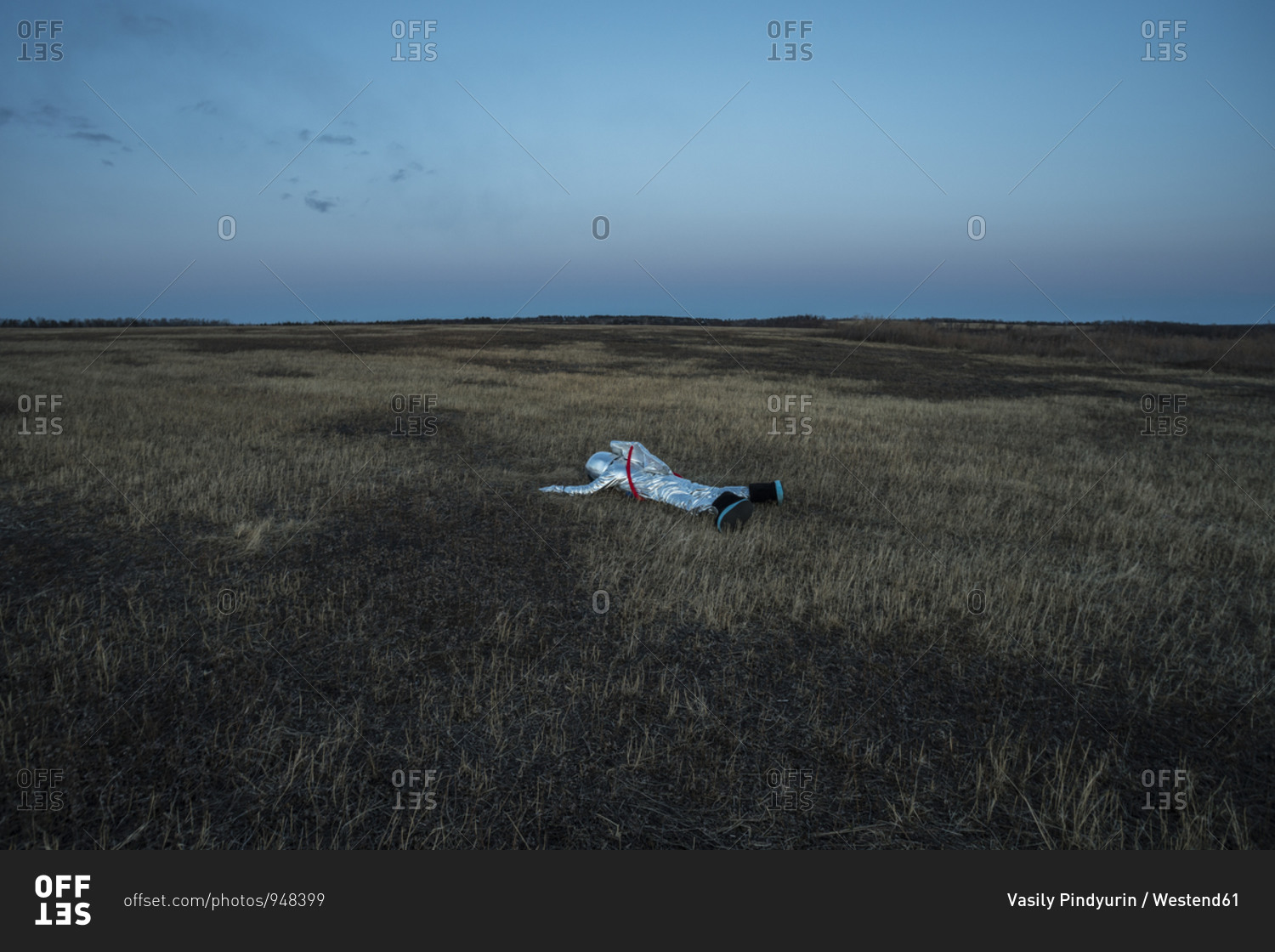 Boy wearing space suit lying on meadow in the evening stock
photo - OFFSET