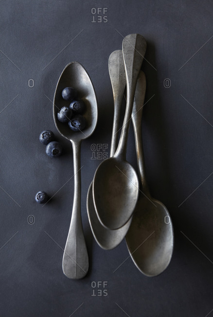 Blueberries with Old Spoons on Tabletop