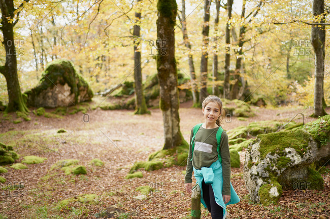 Girl walking through a beech forest