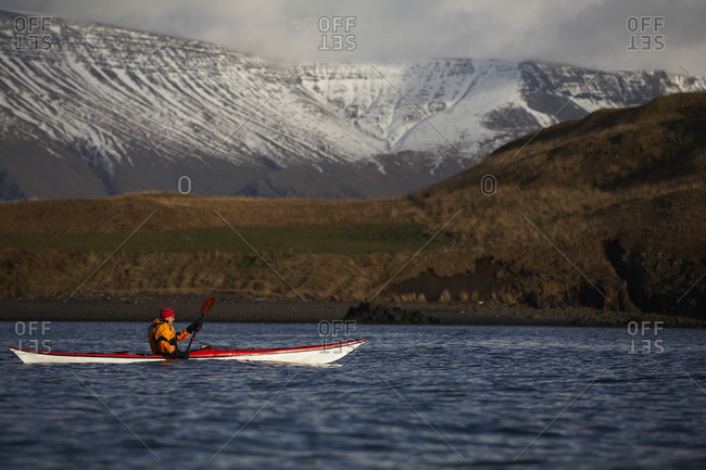 Mature man kayaking around Reykjavik