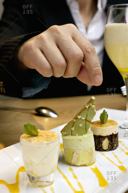 Businesswoman reaching for dessert at luxury hotel restaurant