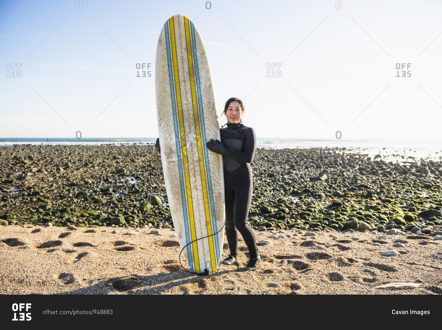 Long Shot portrait of healthy Asian Woman going winter surfing