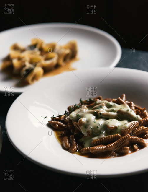 Freshly made pastas and herbs on a moody restaurant table
