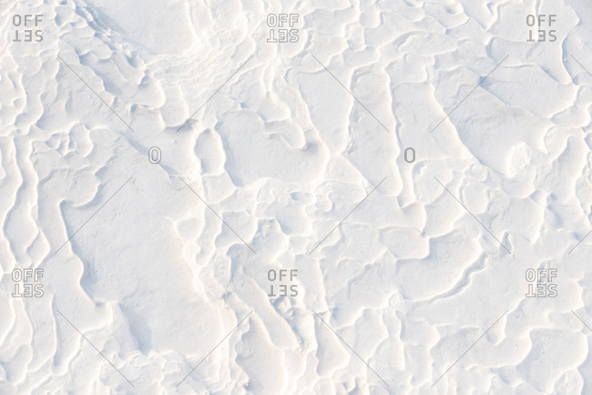 Abstract white limestone textured background in sunny day, Pamukkale, Turkey