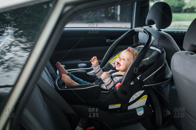 Happy little girl riding in infant car seat