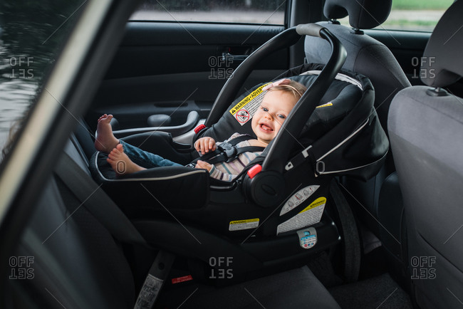 Happy baby girl riding in infant car seat