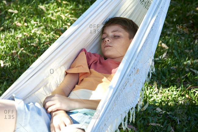 Boy relaxing in hammock alone
