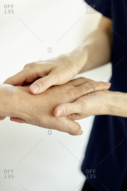 Nurse holding patient's hand softly