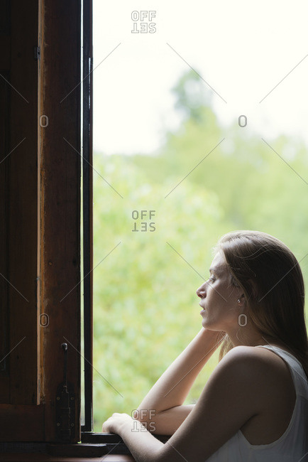 Woman looking through window - Offset