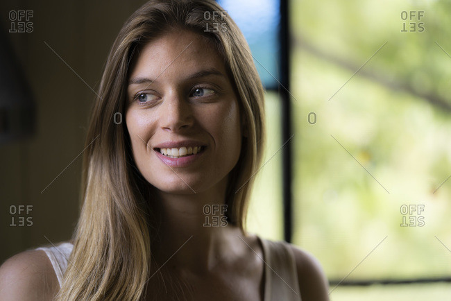 Smiling young woman sitting alone