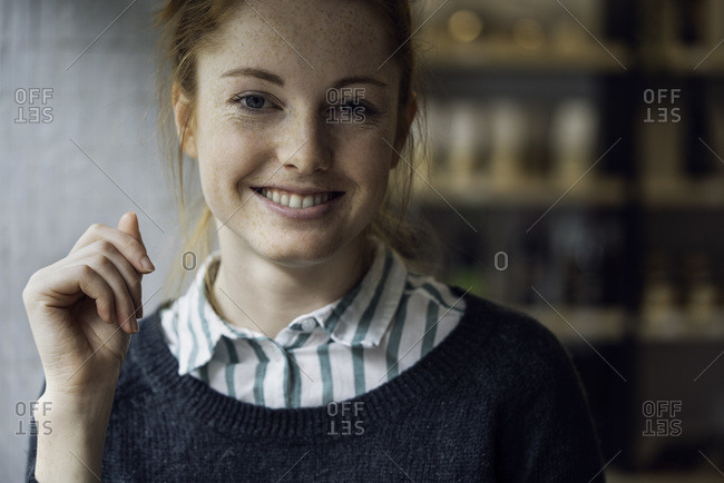 Portrait of smiling woman sitting at home