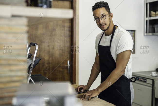 Portrait of man standing in commercial kitchen