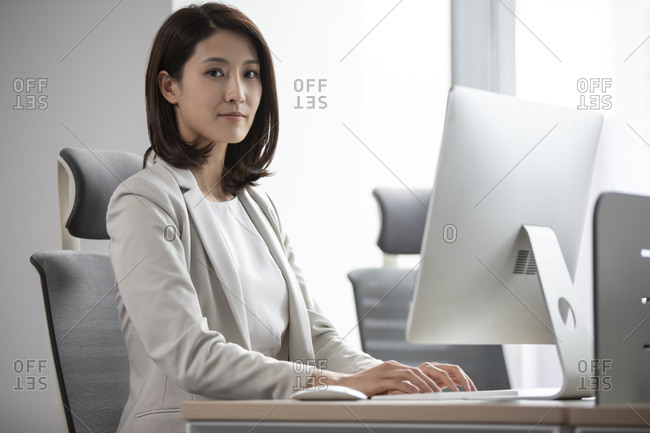 Young Chinese businesswoman working in office