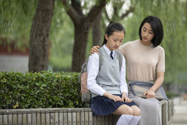 Chinese teacher consoling student outside