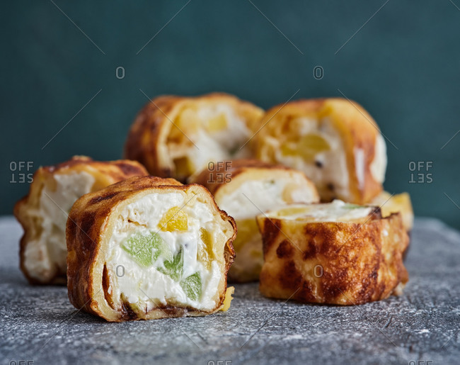 Dessert sushi rolls with kiwi fruit, pineapple, cream cheese and crepes
