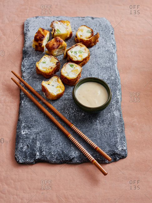 Fusion dessert sushi rolls: rice crepes filled with cream cheese and different sliced fruits