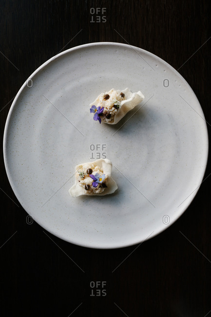 Overhead view of a gourmet dessert with edible flowers