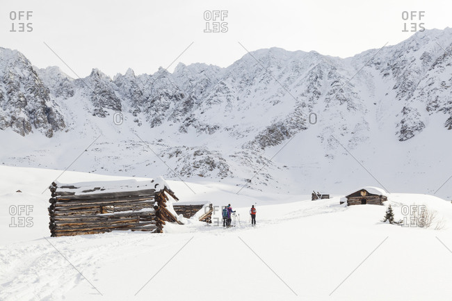 Backcountry skiers outside mine ruins in Mayflower Gulch, Colorado