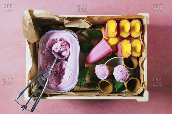 Delicious ice cream and refreshing popsicles in a rustic wooden box
