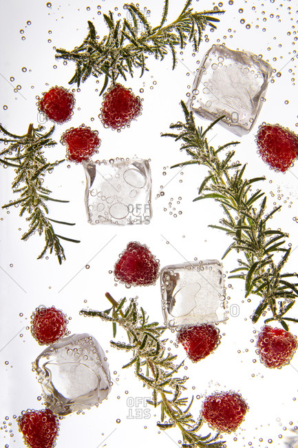 Close up of a cocktail with rosemary and raspberries