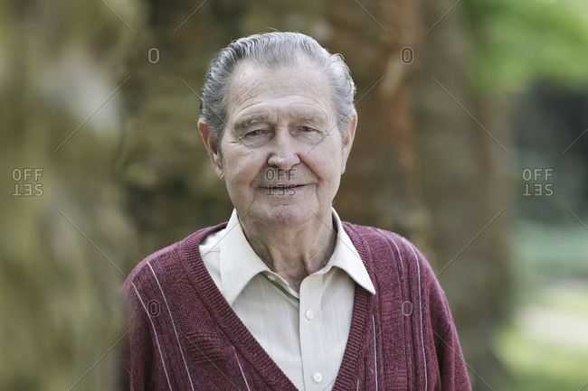 Germany- Cologne- Portrait of senior man in park- close up