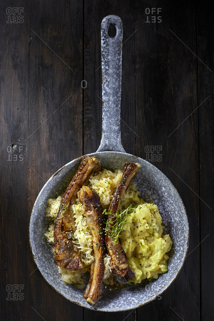 Spare ribs with sauerkraut and mashed potatoes in pan