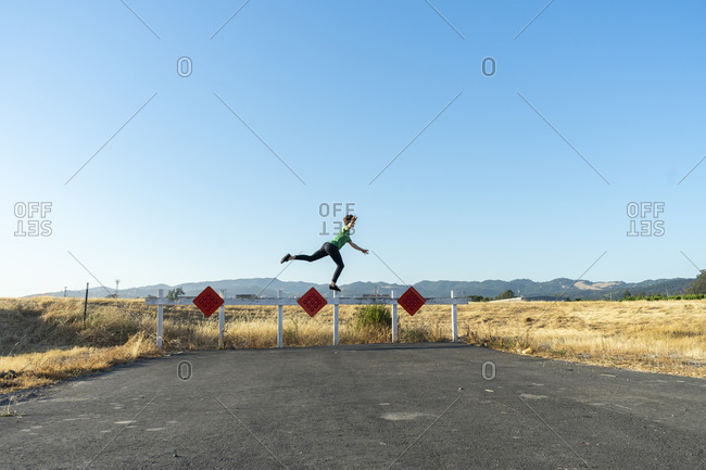 Acrobat balancing on barrier outside