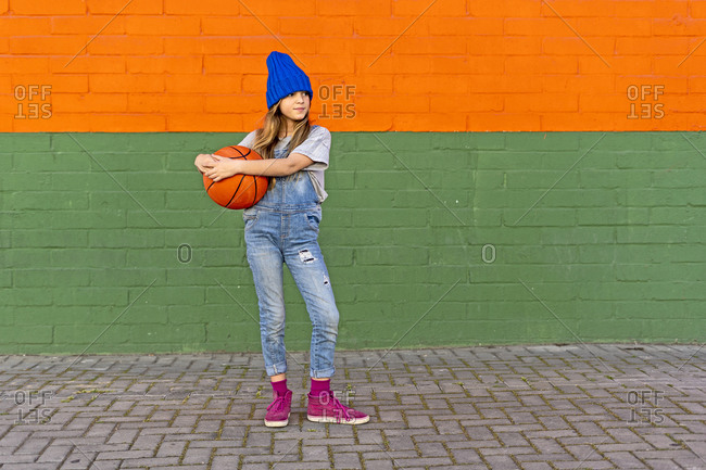 Young girl with basketball outside