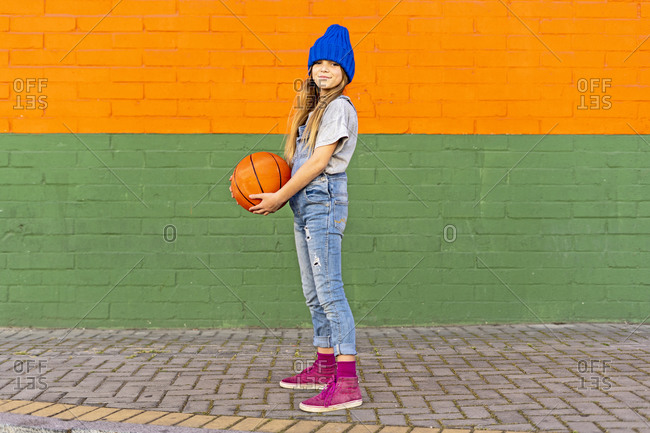 Young girl with basketball outside