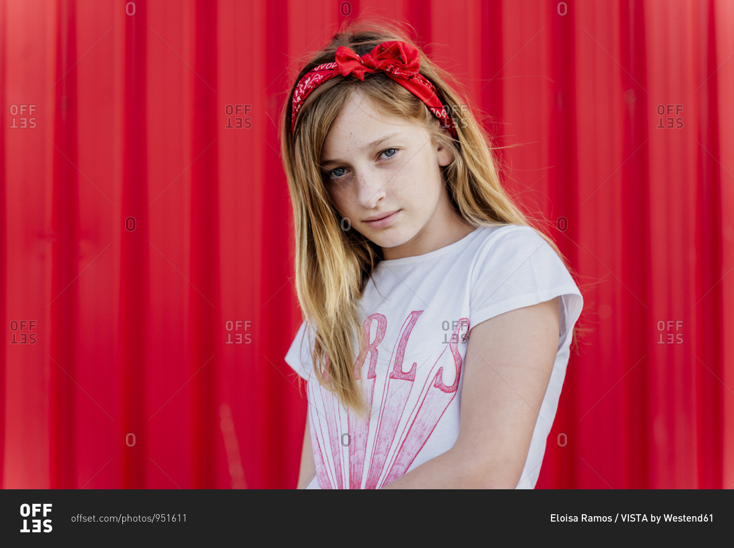 Portrait of girl with hair-band in front of red wall