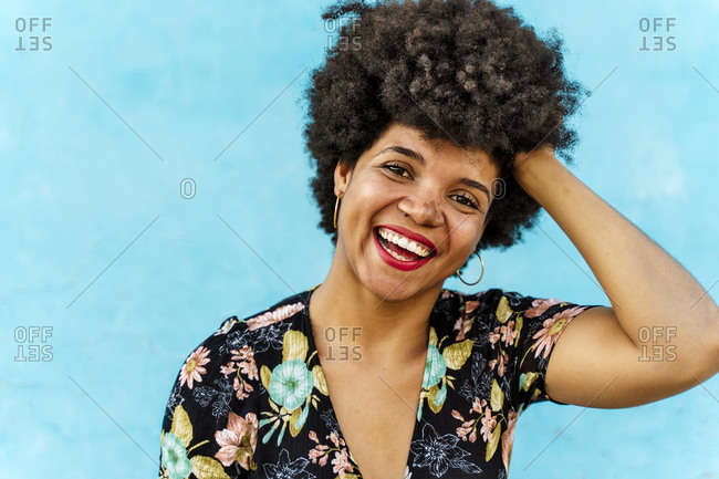 Portrait of smiling female Afro-American woman- hand in hair