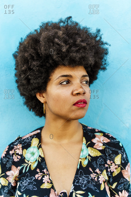 Portrait of female Afro-American woman- blue wall in the background