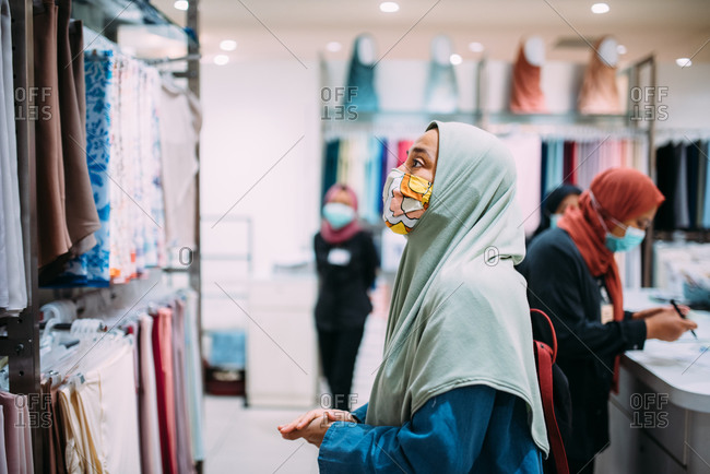 Asian woman in a store wearing a facemask