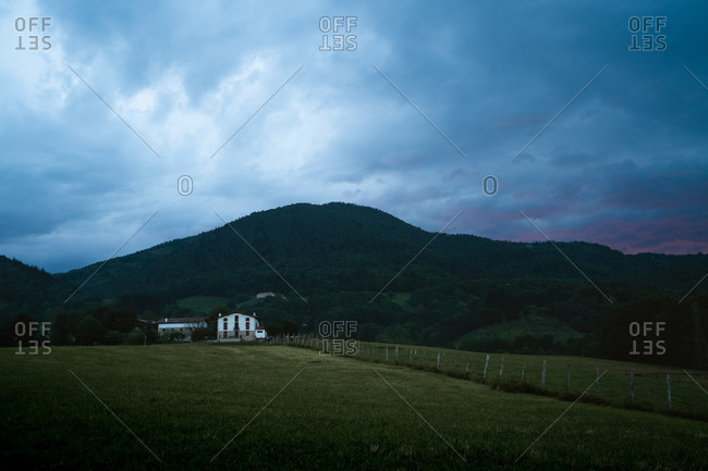 White farm in the Basque Country with dramatic clouds in the background
