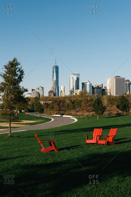 New York City skyline rises over lounge chairs on Governors Island