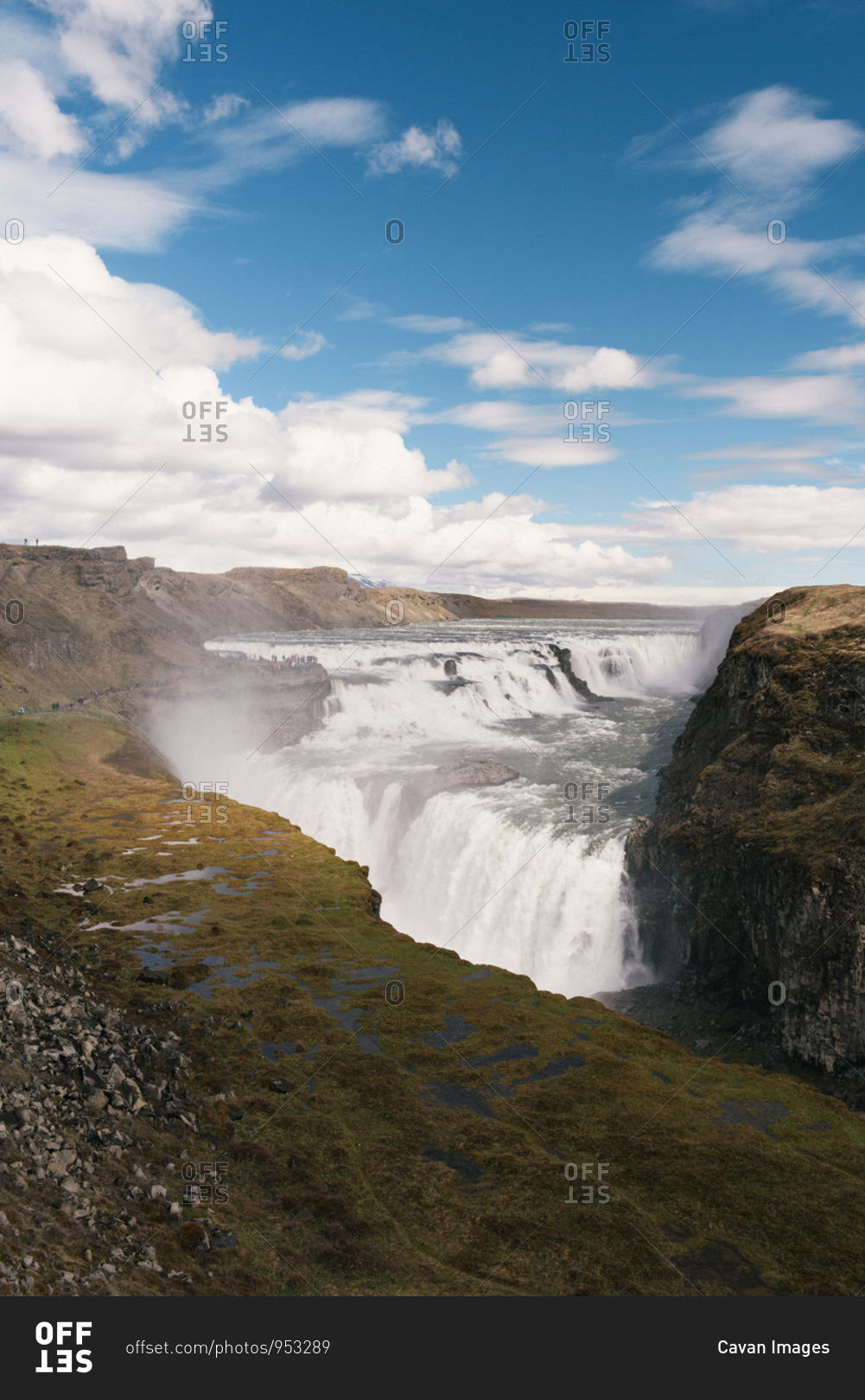 A crowd of tourists gather to watch the power of Gullfoss waterfall