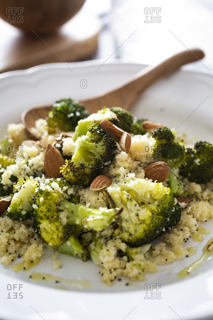 Plate of ready-to-eat couscous with broccoli- garlic and almonds