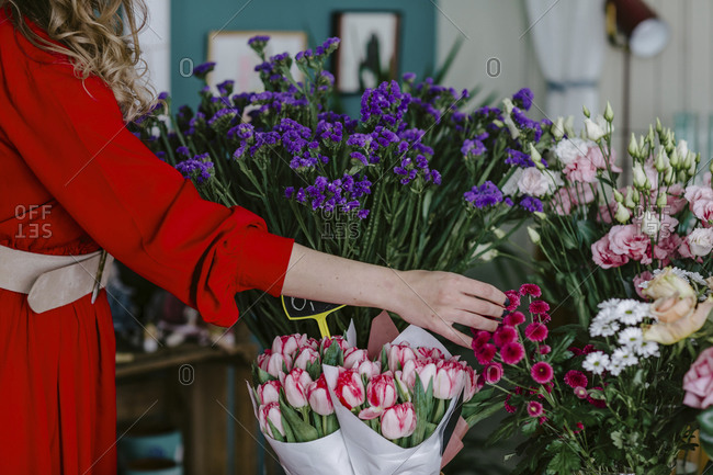Close-up of woman touching flowers in flower shop