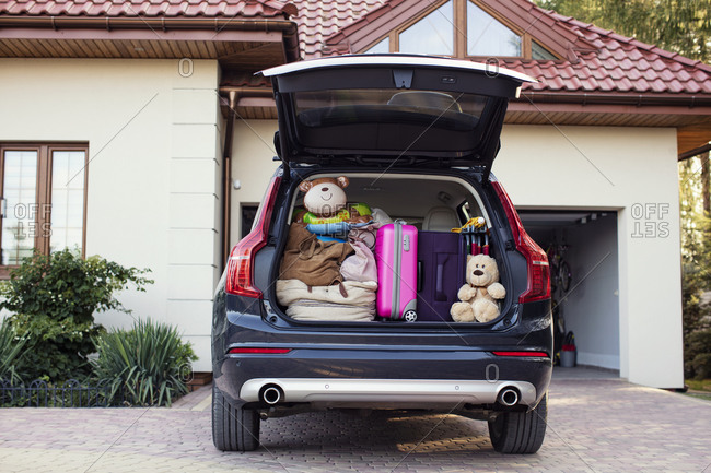 Open car boot packed for family vacation