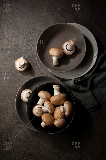 Overhead view of raw mushrooms on plates