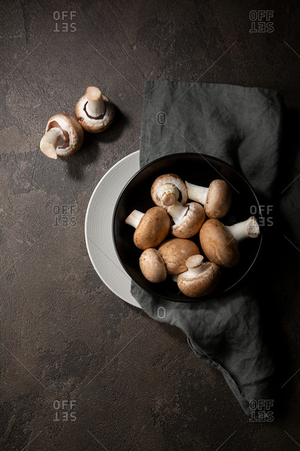 Overhead view of uncooked mushrooms on plates