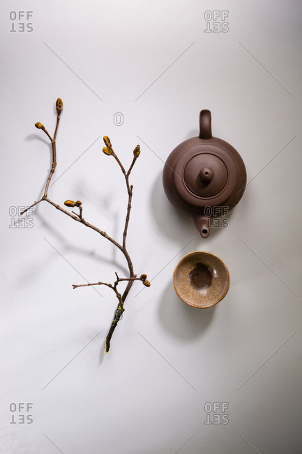 Overhead view of Teapot and teacups on gray surface