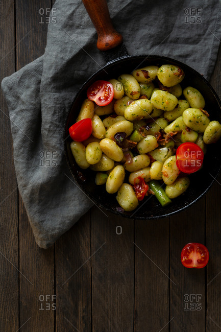 Gnocchi pesto dish on rustic table